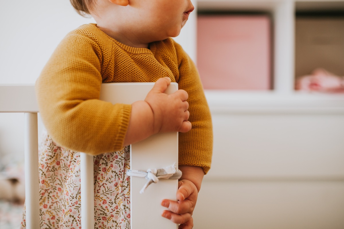 baby holding the cradle