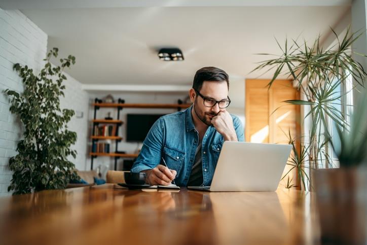 A man in front of his laptop