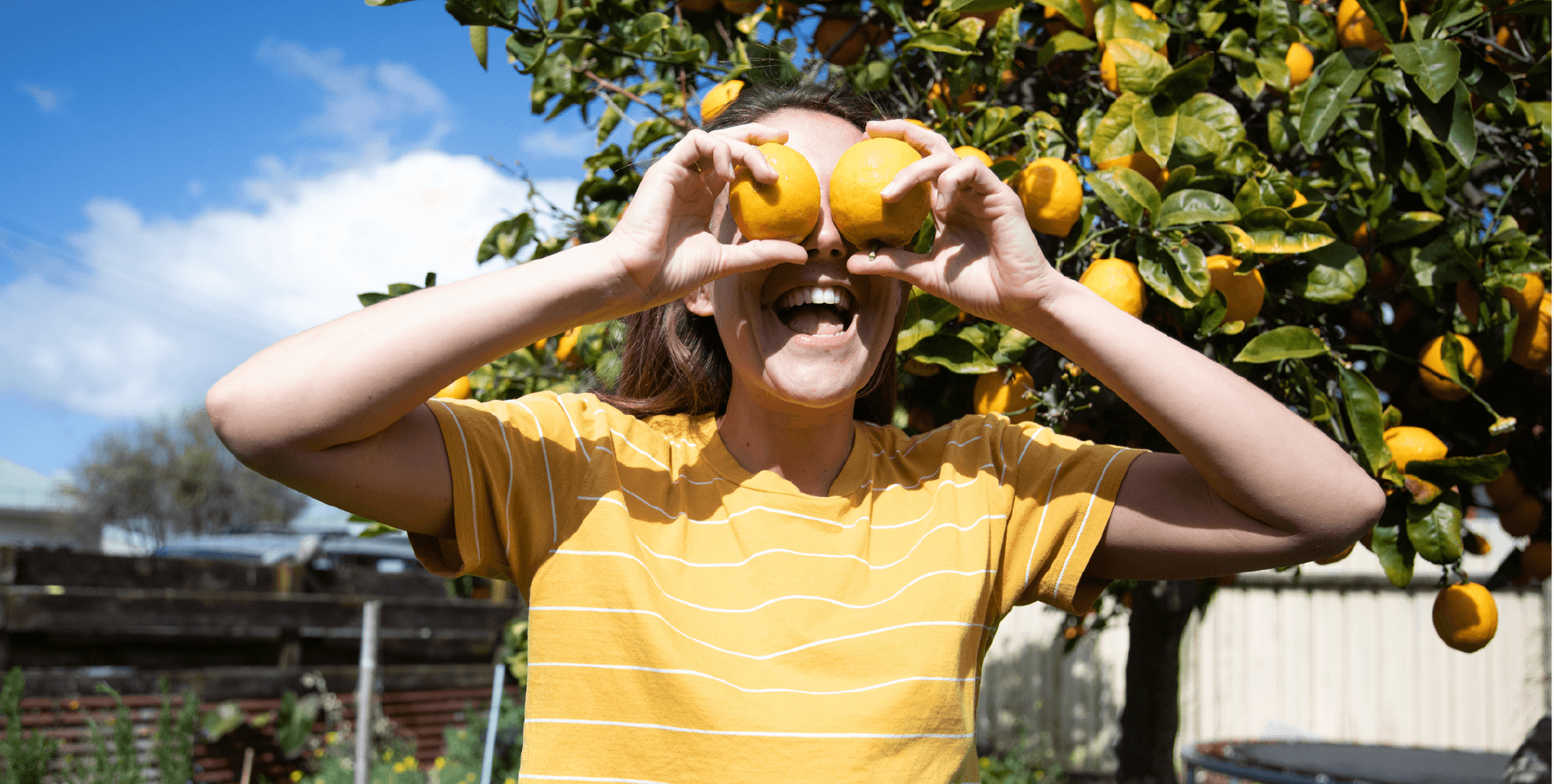 Person holding fruit near eyes