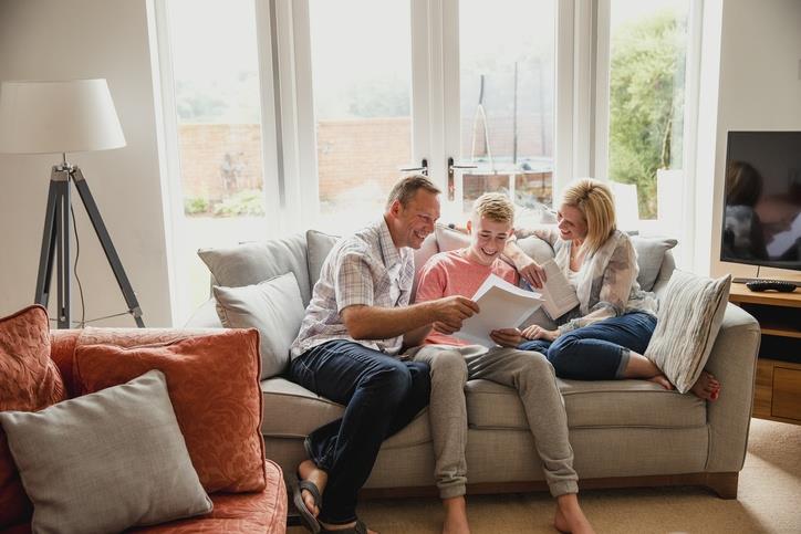 A happy family reading some documents