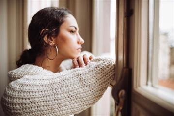 A girl watching out of a window