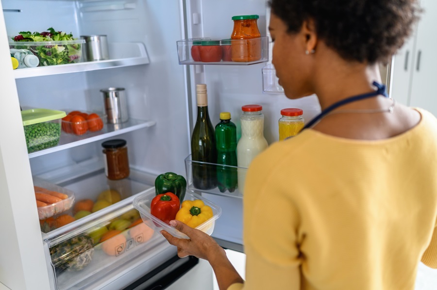 lady_checking_the_vegetables_in_fridge