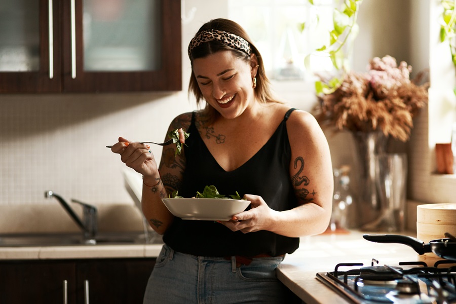 woman eating and laughing