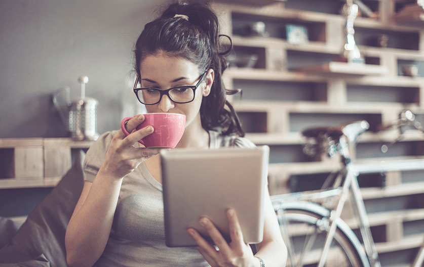 Girl drinking tea with ipad